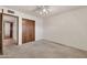 Carpeted bedroom with view of the ensuite bathroom and closet at 5126 W Las Palmaritas Dr, Glendale, AZ 85302