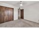 Carpeted bedroom with closet and ensuite bathroom at 5126 W Las Palmaritas Dr, Glendale, AZ 85302
