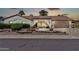 Exterior elevation showcasing desert landscaping, brick archway, and two-car garage at 5126 W Las Palmaritas Dr, Glendale, AZ 85302