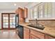 Bright kitchen showcasing wood cabinets, granite countertops, double ovens, and stainless sink at 5126 W Las Palmaritas Dr, Glendale, AZ 85302