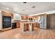 Open-concept kitchen featuring an island, modern appliances, wood cabinets, and ample counter space at 5126 W Las Palmaritas Dr, Glendale, AZ 85302