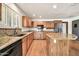 Bright kitchen with granite countertops, an island, wood cabinets, and modern appliances at 5126 W Las Palmaritas Dr, Glendale, AZ 85302