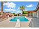Backyard swimming pool with diving board and covered patio area surrounded by desert landscaping under sunny skies at 5126 W Las Palmaritas Dr, Glendale, AZ 85302