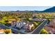Wide aerial view of the residential community near a scenic common green space and mountain views at 5231 W Desperado Way, Phoenix, AZ 85083
