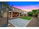 A large backyard featuring artificial turf, a basketball hoop, covered patio, and desert landscaping at 5231 W Desperado Way, Phoenix, AZ 85083