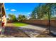 Private backyard featuring artificial turf, basketball hoop, and a desert landscaped retaining wall at 5231 W Desperado Way, Phoenix, AZ 85083