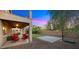 A serene backyard featuring a covered patio, artificial turf, and a paved basketball court area at 5231 W Desperado Way, Phoenix, AZ 85083