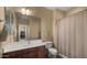 Comfortable bathroom with vanity, sink, shower, mirror, and tan walls at 5231 W Desperado Way, Phoenix, AZ 85083