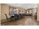 The dining room features a large wood table with seating for ten and beautiful plantation shutters at 5231 W Desperado Way, Phoenix, AZ 85083