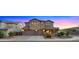 Charming two-story home boasts a three-car garage, stone accents, and manicured front yard at 5231 W Desperado Way, Phoenix, AZ 85083
