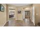 Inviting hallway showcasing arched doorways, neutral paint, and durable tile flooring leading to other rooms at 5231 W Desperado Way, Phoenix, AZ 85083