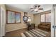Well-lit home office with ample natural light, a desk, seating, and stylish accents. Neutral wall paint throughout at 5231 W Desperado Way, Phoenix, AZ 85083