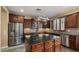 Spacious kitchen featuring stainless steel appliances, a center island, and dark wood cabinets at 5231 W Desperado Way, Phoenix, AZ 85083