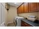Functional laundry room featuring modern washer and dryer, built-in cabinets, and countertop for folding at 5231 W Desperado Way, Phoenix, AZ 85083