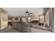 Spacious living room open to the kitchen featuring recessed lighting, plantation shutters and desert views on TV at 5231 W Desperado Way, Phoenix, AZ 85083