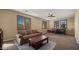 Inviting loft featuring ample natural light, a comfortable sofa, coffee table, and a small dining area at 5231 W Desperado Way, Phoenix, AZ 85083