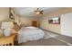 Bright and airy main bedroom with a large bed, ceiling fan, and television for relaxation at 5231 W Desperado Way, Phoenix, AZ 85083