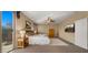 Spacious main bedroom features plush carpet, a ceiling fan, and sliding door access to private balcony at 5231 W Desperado Way, Phoenix, AZ 85083