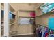 Organized walk-in closet featuring built-in shelves and clothing racks for efficient storage solutions at 5231 W Desperado Way, Phoenix, AZ 85083