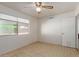 This bedroom features neutral walls, a ceiling fan, and a closet at 525 N 94Th Way, Mesa, AZ 85207
