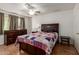 This bedroom features a ceiling fan, closet, and a tiled floor at 525 N 94Th Way, Mesa, AZ 85207