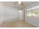 This bedroom features neutral walls, a ceiling fan, and a closet at 525 N 94Th Way, Mesa, AZ 85207