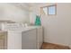 Laundry room with tile floors, shelving, and a window at 525 N 94Th Way, Mesa, AZ 85207