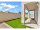 Well-kept backyard features artificial grass and a covered patio at 544 N Alma School Rd # 28, Mesa, AZ 85201