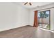 Bright bedroom featuring hardwood floors and a sliding door with backyard access at 544 N Alma School Rd # 28, Mesa, AZ 85201