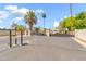 Community entrance with secure gate and palm trees at 544 N Alma School Rd # 28, Mesa, AZ 85201