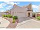 Stylish beige stucco home featuring a two-car garage, desert landscaping, and well-maintained walkway at 544 N Alma School Rd # 28, Mesa, AZ 85201