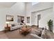 Bright living room with high ceilings, neutral decor, wood blinds, and modern furnishings, perfect for entertaining at 544 N Alma School Rd # 28, Mesa, AZ 85201