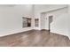 Open-concept living space with sleek hardwood floors, large windows with wood blinds, and a modern staircase at 544 N Alma School Rd # 28, Mesa, AZ 85201