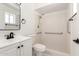 Bright bathroom with grab bars in the tiled shower and a vanity with a black faucet at 632 N 95Th St, Mesa, AZ 85207