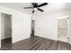 Bedroom with wood-look floors, access to a closet, and a bathroom with accessibility features at 632 N 95Th St, Mesa, AZ 85207