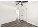 View of a bedroom featuring a ceiling fan, wood-look floors, closet, and an en-suite bathroom at 632 N 95Th St, Mesa, AZ 85207