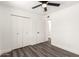 Bedroom with a ceiling fan, wood-look floors, closet, and access to an en-suite bathroom at 632 N 95Th St, Mesa, AZ 85207