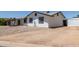 Single-story home with rock landscaping, dark trim and white siding at 632 N 95Th St, Mesa, AZ 85207
