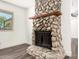 Close-up of stone fireplace with wooden mantel and decorative hearth at 632 N 95Th St, Mesa, AZ 85207