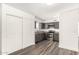 Modern kitchen features gray cabinets, stainless steel appliances, and gray wood-look flooring at 632 N 95Th St, Mesa, AZ 85207