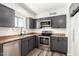 Stylish kitchen features gray cabinets, stainless steel appliances, and ample counter space at 632 N 95Th St, Mesa, AZ 85207