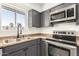 Well-appointed kitchen with stainless steel appliances and gray cabinetry at 632 N 95Th St, Mesa, AZ 85207