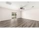Spacious living room boasts modern gray wood-look flooring and access to the backyard at 632 N 95Th St, Mesa, AZ 85207