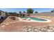Backyard with sparkling pool, mature landscaping, covered patio, and privacy fence at 632 N 95Th St, Mesa, AZ 85207