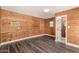 Wood-paneled room features neutral flooring, air conditioning, and a convenient half bathroom at 632 N 95Th St, Mesa, AZ 85207