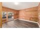 Wood-paneled room featuring new flooring, neutral paint, and a convenient back door at 632 N 95Th St, Mesa, AZ 85207