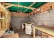 Unfinished interior of the shed featuring concrete walls and exposed wood frame and rafters at 632 N 95Th St, Mesa, AZ 85207