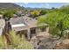 A high angle view shows a desert home's covered patio and low-maintence desert landscaping at 6579 E Shooting Star Way, Scottsdale, AZ 85266