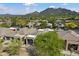 Aerial view of a residential community with mountain views and lush desert landscaping at 6579 E Shooting Star Way, Scottsdale, AZ 85266
