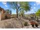 Desert backyard features drought-tolerant landscaping and views of the green golf course at 6579 E Shooting Star Way, Scottsdale, AZ 85266